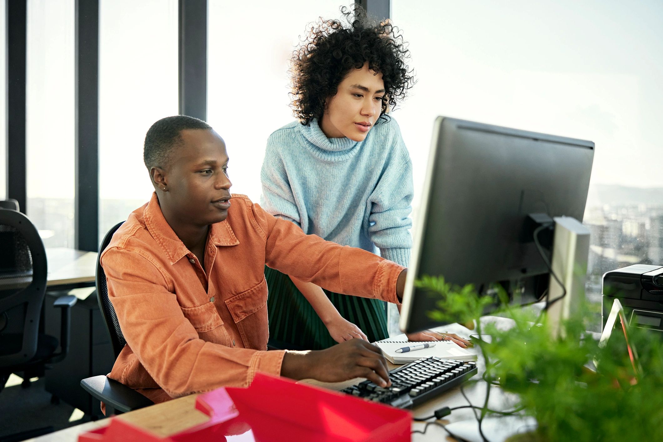 Small business professionals reviewing work at a computer