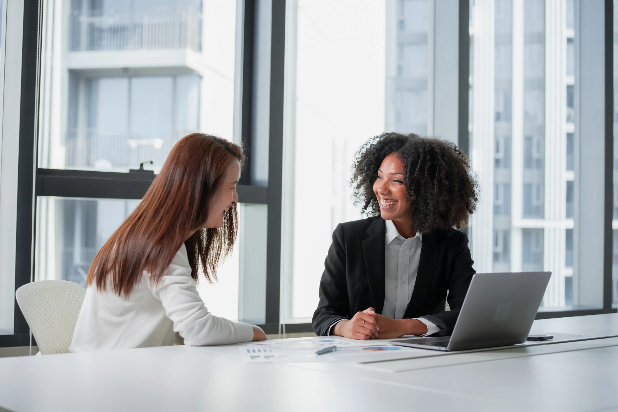 Two professionals reviewing technology plans in a modern office